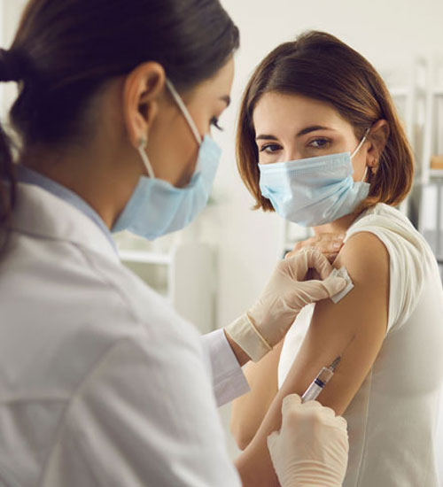 Doctor,Giving,A,Senior,Woman,A,Vaccination.,Virus,Protection.,Covid-2019.